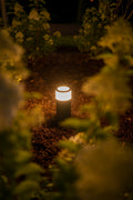 Garden pathway light casting a warm glow along a walkway