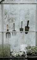 Set of handheld garden tools hanging on a rack