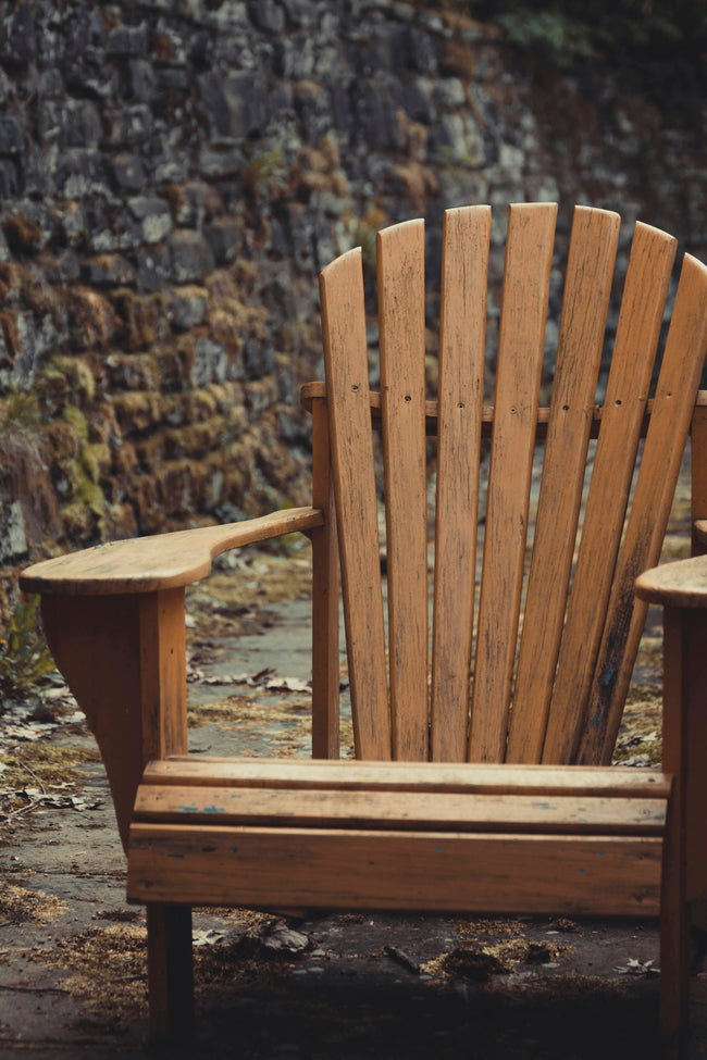 Wooden Adirondack chair outdoors in natural daylight