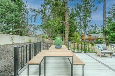 Small outdoor table on a patio holding a potted plant